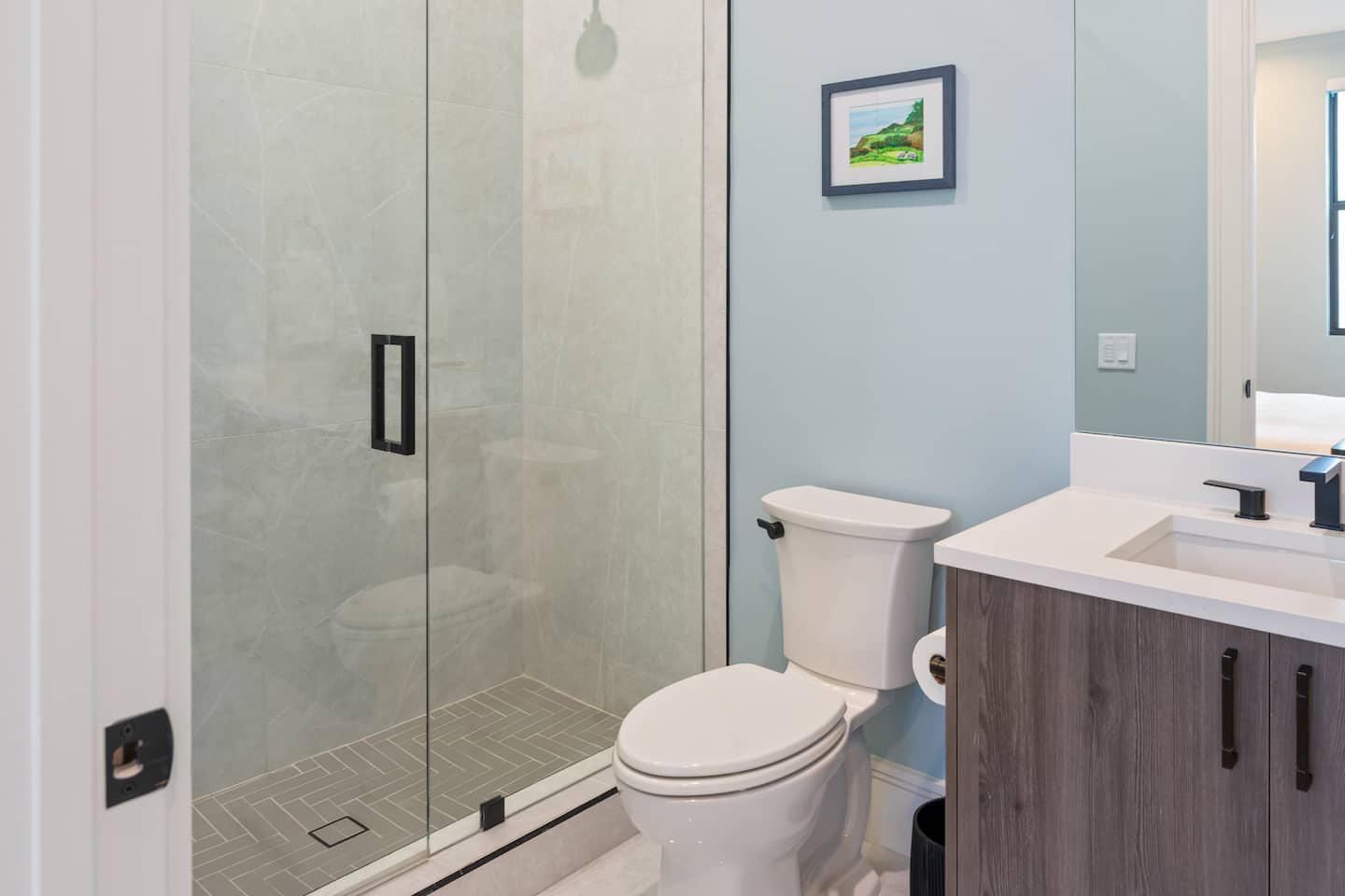 Ensuite bathroom with walk-in shower and stone tile